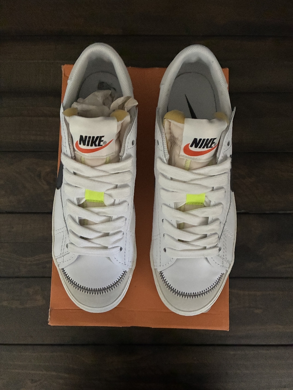 Nike White Low-Top Sneakers with Black Swoosh and Neon Yellow Tabs